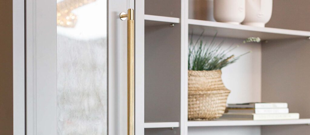 close up of gold handle and ornaments on shelves