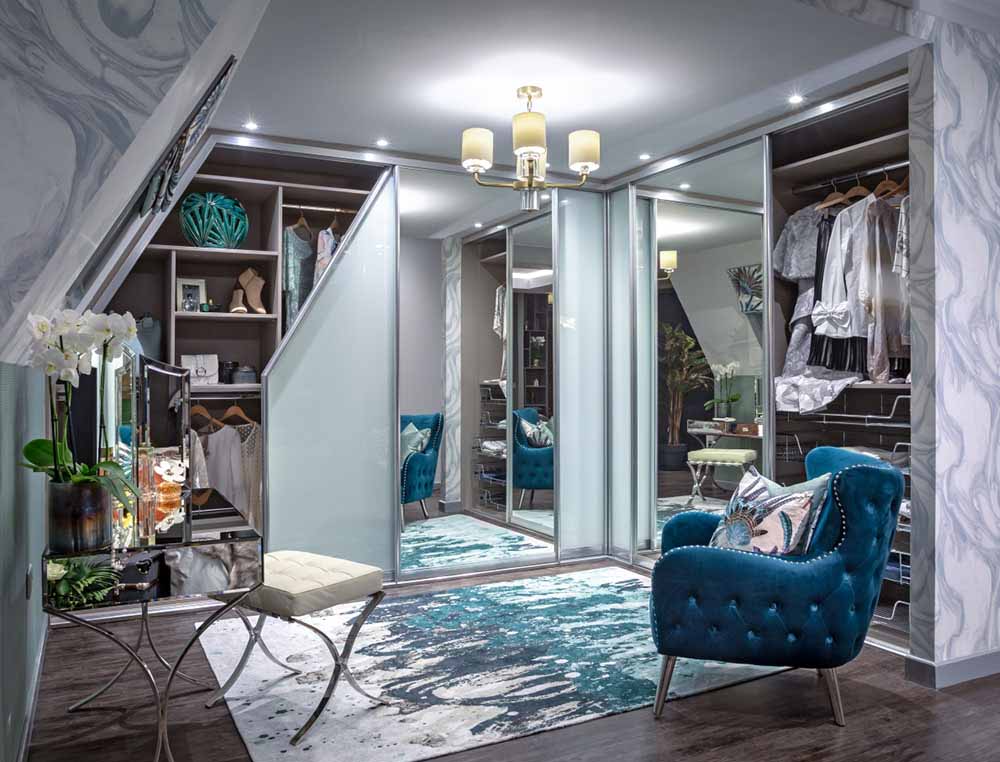 sliding angled wardrobe open with clothes inside