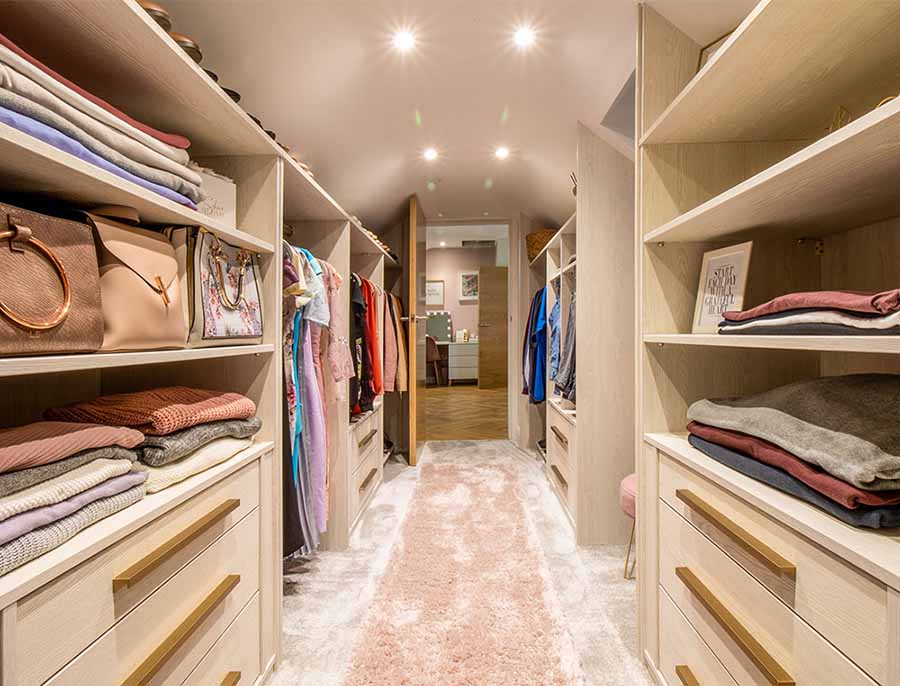 walk in wardrobe with units either side