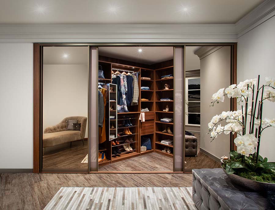 walk in sliding wardrobe with mens clothes inside